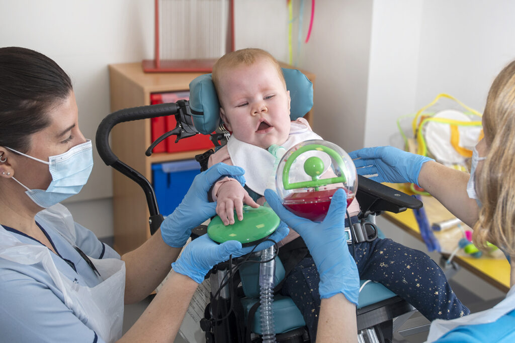 two nurses playing with a baby