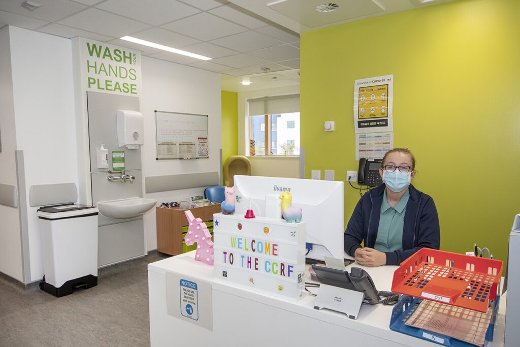 reception desk for clinical research with receptionist lady sitting at it