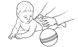 baby lying on stomach looking at a ball on the left