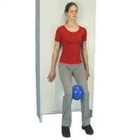 A diagram of a woman standing against the wall with feet about 30cm out from it. She is bending her knees and has a small blue ball between her legs she is squeezing 