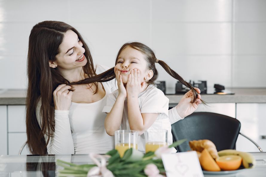 A joyful moment between mother and daughter at breakfast
